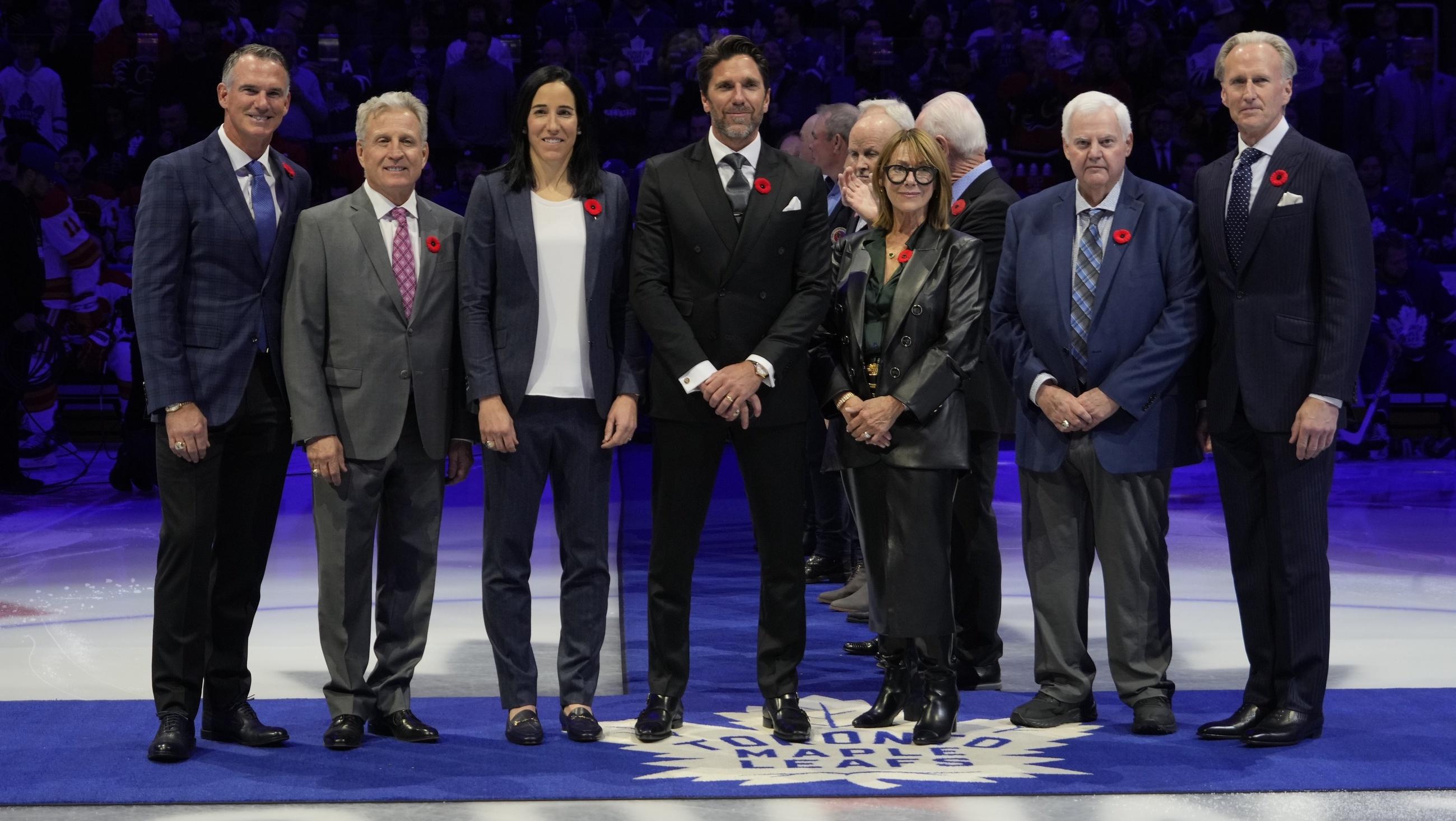 Hockey Hall of Fame Class of 2023 inductees Pierre Turgeon, Mike Vernon, Caroline Ouellette, Henrik Lundqvist, Coco Lacroix for her husband Pierre , Ken Hitchcock, and Tom Barrasso (left to right) before the start of the game between the Calgary Flames and Toronto Maple Leafs at Scotiabank Arena. / John E. Sokolowski-USA TODAY Sports