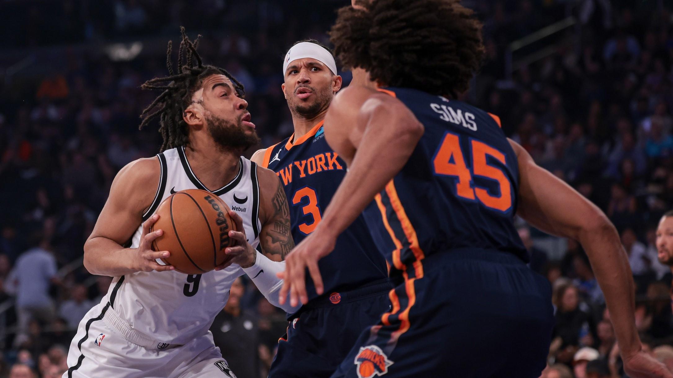 Apr 12, 2024; New York, New York, USA; Brooklyn Nets forward Trendon Watford (9) drives to the basket against New York Knicks guard Josh Hart (3) and center Jericho Sims (45) during the first quarter at Madison Square Garden. / Vincent Carchietta-USA TODAY Sports
