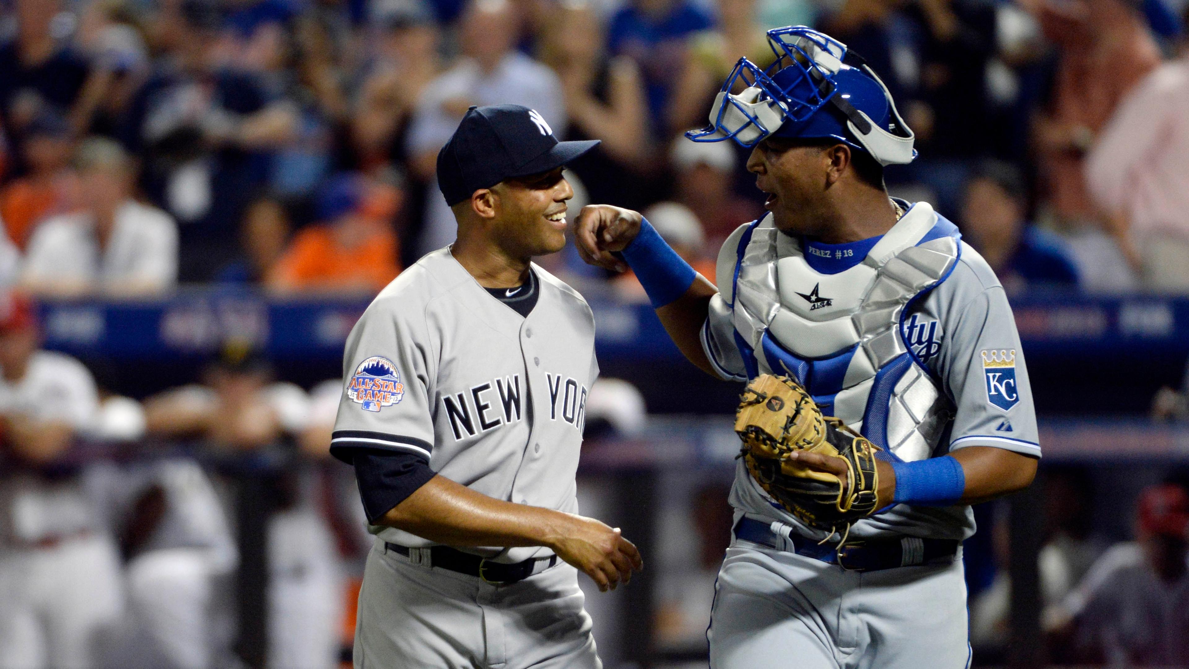 American League pitcher Mariano Rivera (42) of the New York Yankees walks off the field with catcher Salvador Perez (13) of the Kansas City Royals after retiring the National League in the 8th inning. / USA TODAY-USA TODAY Sports