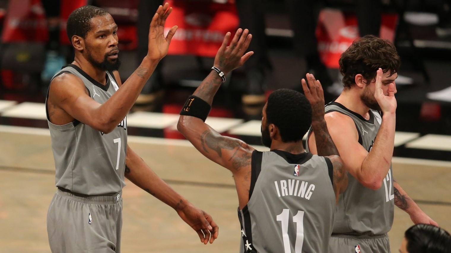 Jan 3, 2021; Brooklyn, New York, USA; Brooklyn Nets small forward Kevin Durant (7) high fives point guard Kyrie Irving (11) during the second quarter against the Washington Wizards at Barclays Center. / Brad Penner-USA TODAY Sports