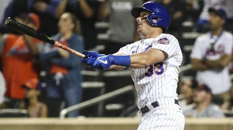 Jun 25, 2021; New York City, New York, USA; New York Mets pinch hitter James McCann (33) hits the game-tying sacrifice fly in the eighth inning against the Philadelphia Phillies at Citi Field / Wendell Cruz-USA TODAY Sports