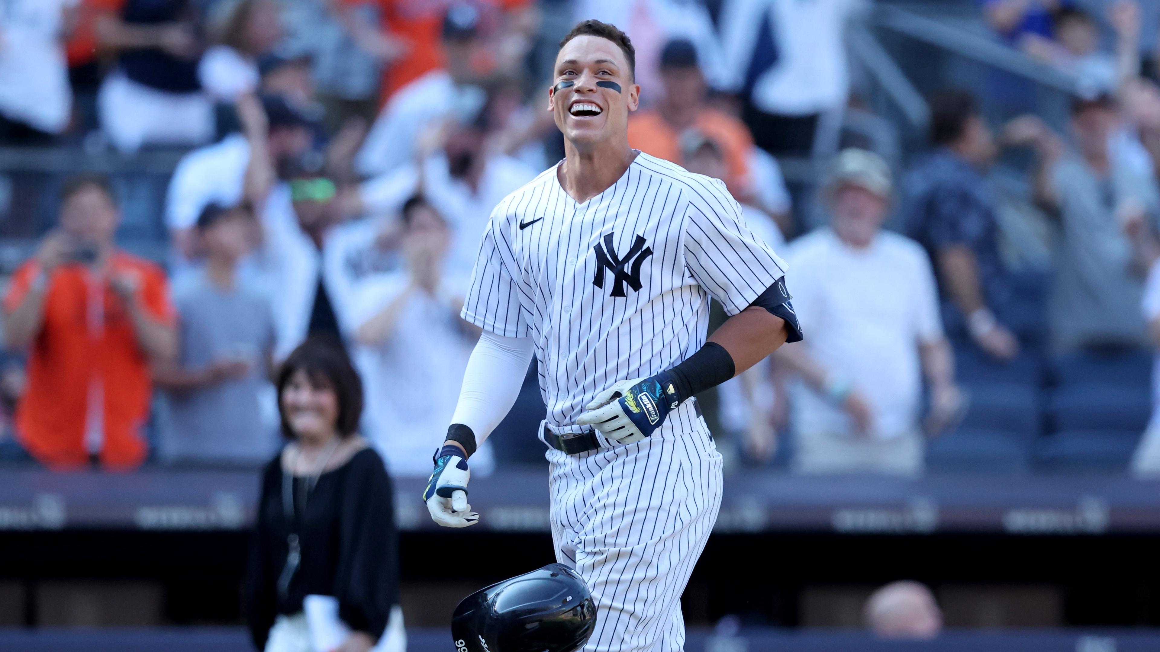 Jun 26, 2022; Bronx, New York, USA; New York Yankees center fielder Aaron Judge (99) tosses his helmet as he comes home after hitting a game winning walk off three run home run against the Houston Astros during the tenth inning at Yankee Stadium. / Brad Penner-USA TODAY Sports