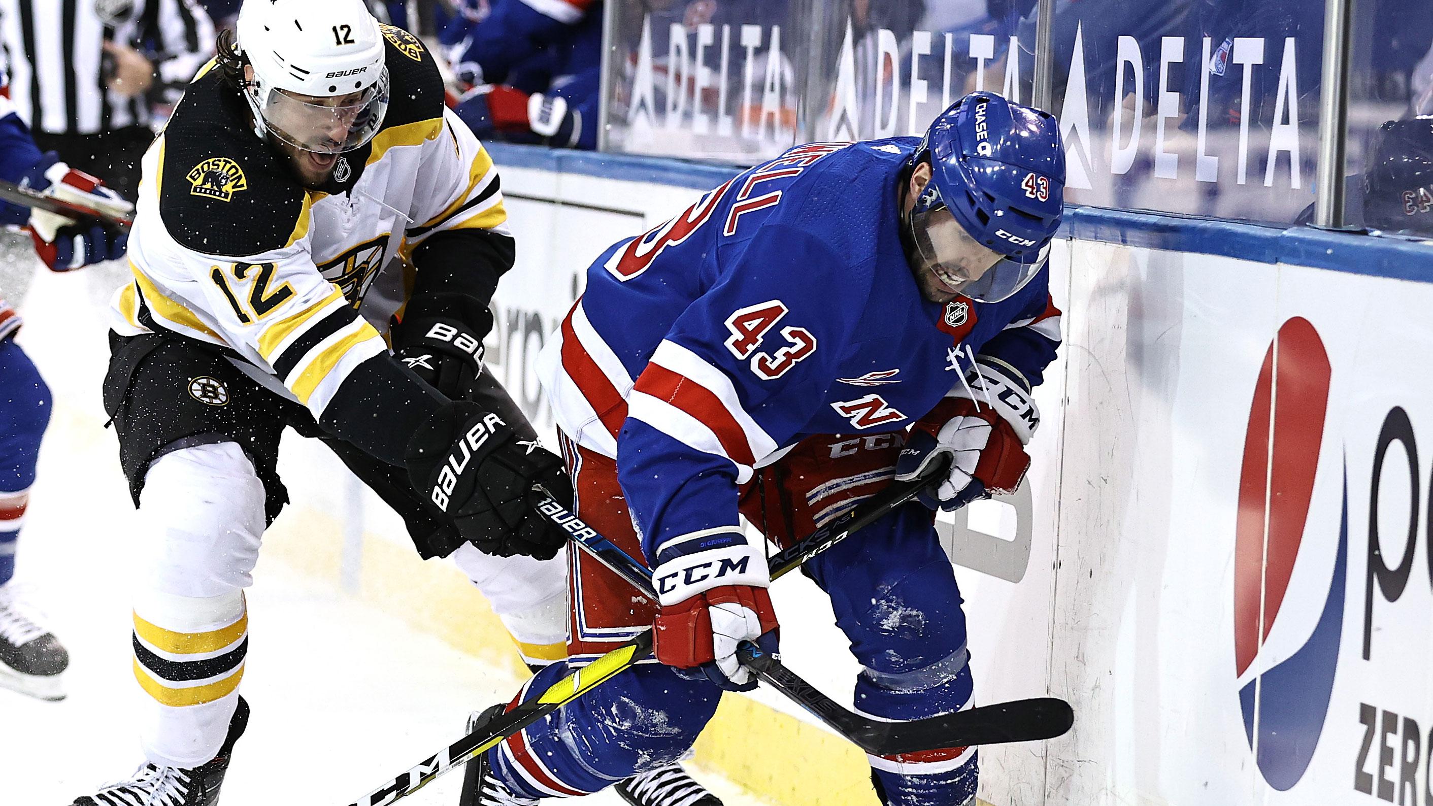 Feb 12, 2021; New York, New York, USA; Boston Bruins right wing Craig Smith (12) and New York Rangers center Colin Blackwell (43) fight for the puck in the first period at Madison Square Garden. / Elsa/Pool Photos-USA TODAY Sports