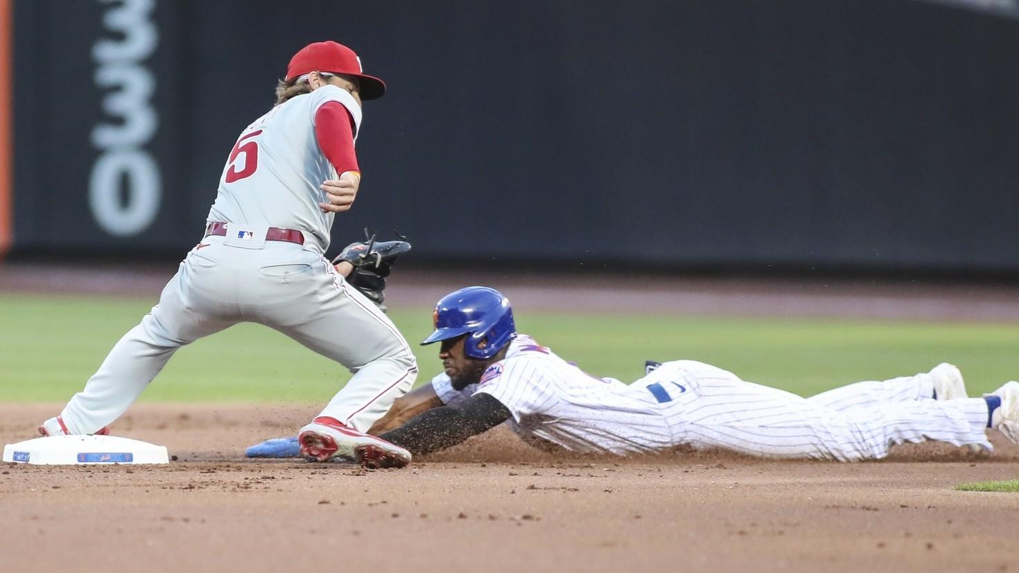 Philadelphia Phillies shortstop Bryson Stott (5) is unable to handle the throw allowing New York Mets right fielder Starling Marte (6) to steal second base in the first inning at Citi Field. / Wendell Cruz-USA TODAY Sports