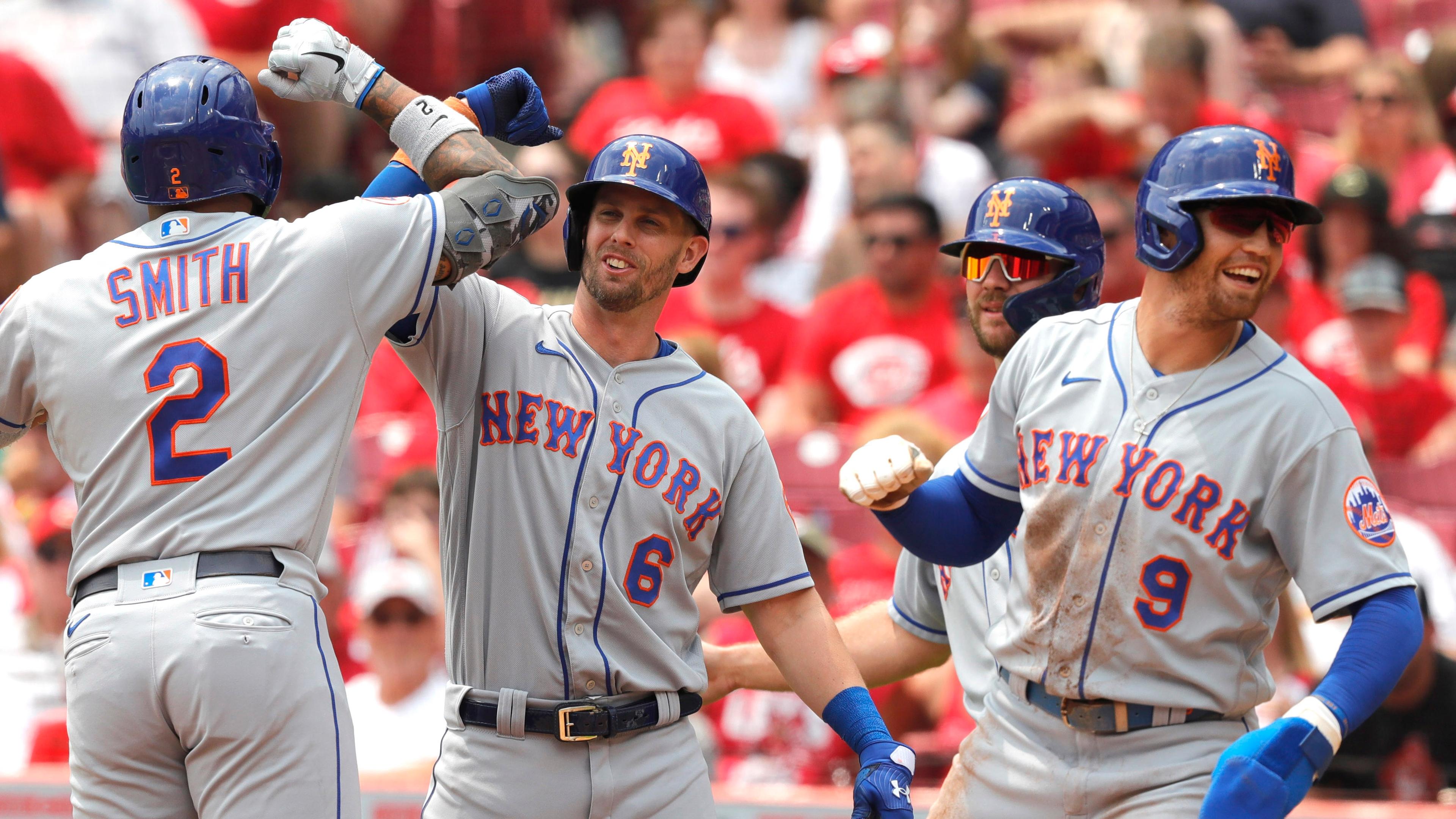 Jul 21, 2021; Cincinnati, Ohio, USA; New York Mets left fielder Dominic Smith (2) celebrates with second baseman Jeff McNeil (6) center fielder Brandon Nimmo (9) and first baseman Pete Alonso (20) after hitting a grand slam home run against the Cincinnati Reds in the third inning at Great American Ball Park. / David Kohl-USA TODAY Sports